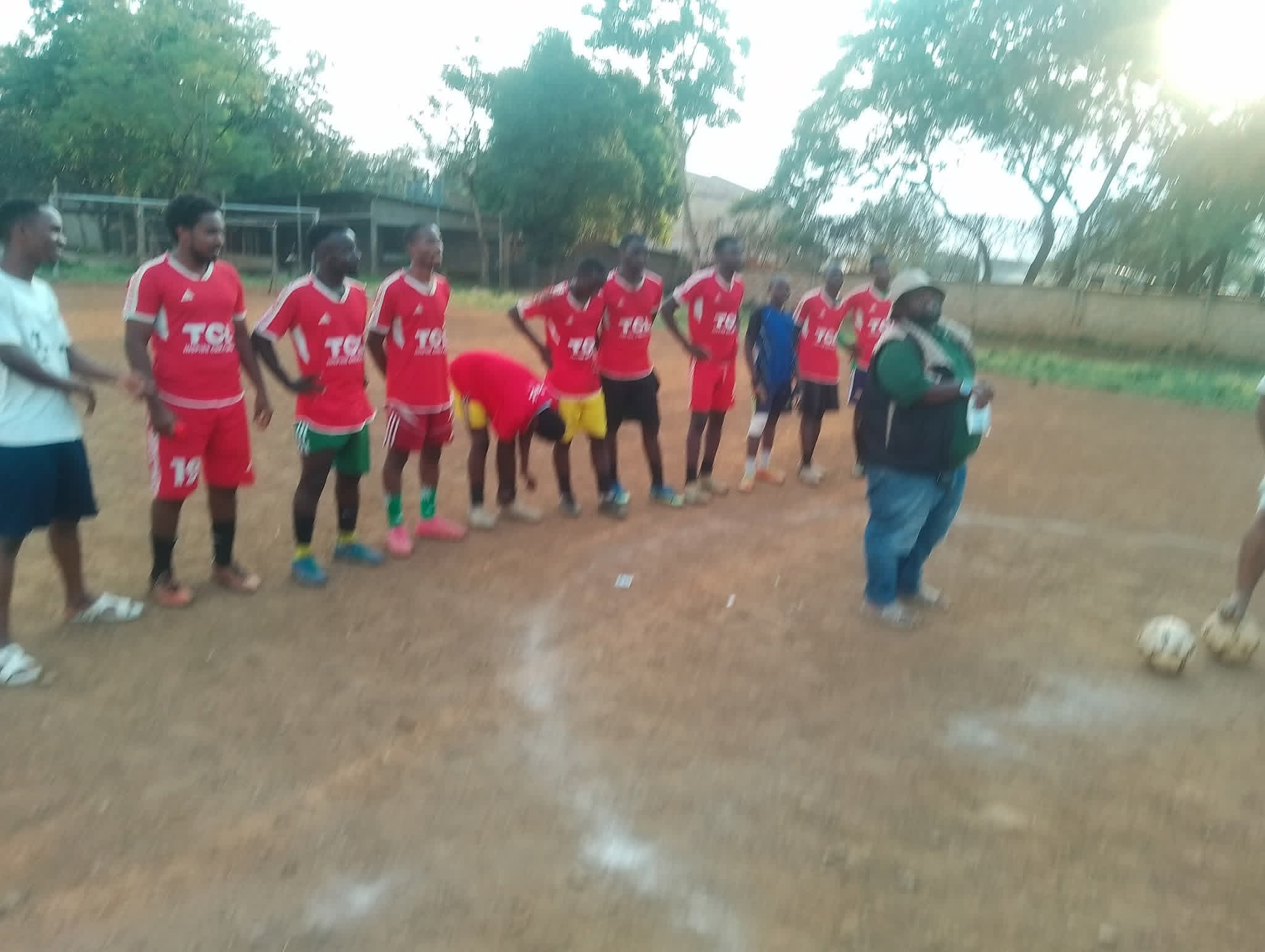 A team in red jerseys lined up on the pitch before a match at the Inter-Masjid Football Tournament in Kisumu.